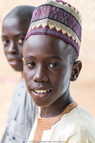 Nigeria, Kano State, Kano. Two young Hausa boys in Islamic dress.